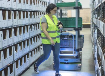 Woman using Pyxis Point and Lumabot in warehouse