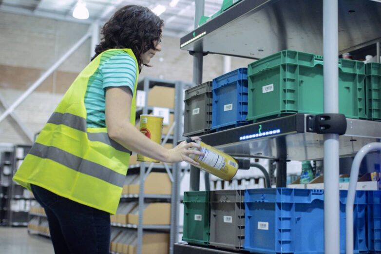 Woman using Lumabot for picking in warehouse