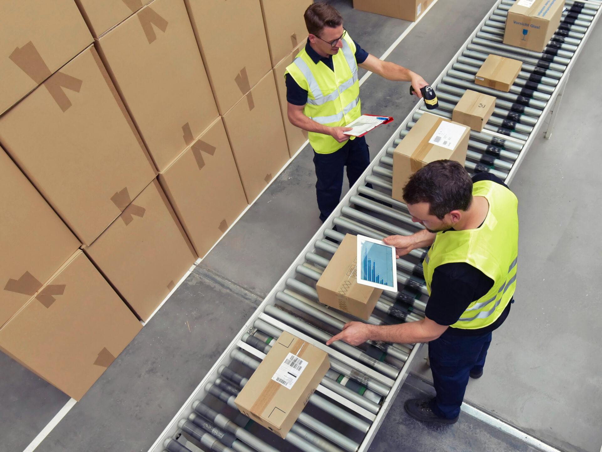 logistics workers in a warehouse in the logistics sector processing packages on the assembly line - transport and processing of orders in trade